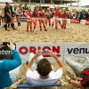 Men watch as participants celebrate after the 2012 Sexy Soccer match between erotic actresses posing as German and Danish teams, in Berlin